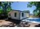 Cozy home with white siding and black trim, complemented by a new concrete driveway and a sunny yellow back door at 4244 Lindsey Dr, Decatur, GA 30035