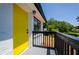 Close up of yellow front door and black railings that welcomes you to enjoy the outdoors from the front porch at 4244 Lindsey Dr, Decatur, GA 30035