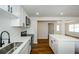 Modern kitchen showcasing white cabinetry, stainless steel appliances, quartz countertops, and a kitchen island at 4244 Lindsey Dr, Decatur, GA 30035