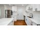 Modern kitchen featuring white cabinets, stainless steel appliances, quartz countertops, and hardwood flooring at 4244 Lindsey Dr, Decatur, GA 30035