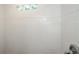 Tiled shower with glass block window for natural light and a sleek, modern look at 4244 Lindsey Dr, Decatur, GA 30035