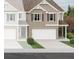 New construction home with brick and siding, paired with a white garage door and charming landscaping at 426 Lanier Cir, Woodstock, GA 30189