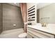 The bathroom includes tile surround, vanity, and a shower-tub combination with modern fixtures at 4327 Azalea Ridge Way, Hoschton, GA 30548