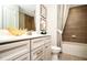 Bathroom with double sink vanity, white countertops, tiled shower and tub at 4327 Azalea Ridge Way, Hoschton, GA 30548