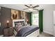 Bedroom features a white bed frame, stylish lamps, decor, and a window with green curtains at 4327 Azalea Ridge Way, Hoschton, GA 30548