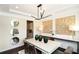 Chic dining room with decorative mirrors, wall decor, contemporary lighting, and hardwood floors at 4327 Azalea Ridge Way, Hoschton, GA 30548