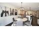 Bright dining area with modern chandelier and view to the open kitchen at 4327 Azalea Ridge Way, Hoschton, GA 30548