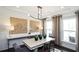 Elegant dining room featuring modern lighting, wood paneling, console table and sophisticated décor at 4327 Azalea Ridge Way, Hoschton, GA 30548