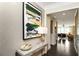 Stylish home entryway showcases a console table with décor, eye-catching wall art and hardwood floors at 4327 Azalea Ridge Way, Hoschton, GA 30548