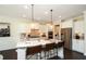 Spacious kitchen with stainless steel appliances, quartz countertops, and large island with seating at 4327 Azalea Ridge Way, Hoschton, GA 30548