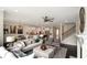 Open-concept living room with modern decor flows into a bright, eat-in kitchen at 4327 Azalea Ridge Way, Hoschton, GA 30548