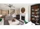 Stylish living room features a fireplace, modern ceiling fan, and staircase at 4327 Azalea Ridge Way, Hoschton, GA 30548