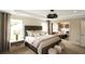 Spacious bedroom with neutral tones and view into a cozy sitting room at 4327 Azalea Ridge Way, Hoschton, GA 30548