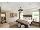 Serene bedroom with elegant chandelier and large windows, lots of light at 4327 Azalea Ridge Way, Hoschton, GA 30548