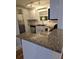 Updated kitchen showcasing granite countertop and stainless steel appliances at 48 Peachtree Ne Ave # 321, Atlanta, GA 30305