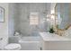 Modern bathroom featuring marble tile, white vanity, and gold fixtures in a well-lit space at 995 Lena Nw St, Atlanta, GA 30314