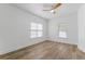 Bright bedroom with wood-look flooring, ceiling fan, and two windows providing ample natural light at 995 Lena Nw St, Atlanta, GA 30314