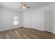 Spacious bedroom featuring a neutral color palette, wood-look floors, and a classic ceiling fan at 995 Lena Nw St, Atlanta, GA 30314