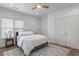 Serene bedroom with a ceiling fan, a comfortable queen bed, and closet doors at 995 Lena Nw St, Atlanta, GA 30314