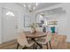 Bright dining area with a modern chandelier, round table, and open access to the updated kitchen at 995 Lena Nw St, Atlanta, GA 30314