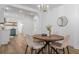 Bright dining area with a modern chandelier, round table, and open access to the updated kitchen at 995 Lena Nw St, Atlanta, GA 30314