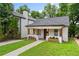 Inviting single-story house featuring a cozy front porch with wooden columns and blossoming flower boxes at 995 Lena Nw St, Atlanta, GA 30314