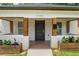 Cozy front porch with wood columns, brick supports, and planters creating an inviting entrance to the home at 995 Lena Nw St, Atlanta, GA 30314