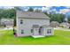 View of the backyard with a green lawn and grey siding on the house at 2090 Harvester Ln, Buford, GA 30518
