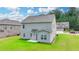 View of the backyard with a green lawn and grey siding on the house at 2090 Harvester Ln, Buford, GA 30518