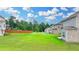 Large green backyard with a wooden fence and views of neighboring homes at 2090 Harvester Ln, Buford, GA 30518