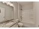Bathroom with granite countertop, white cabinets, and a shower and tub combo at 2090 Harvester Ln, Buford, GA 30518