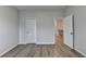 Bedroom featuring neutral paint, wood floors, and open doorways at 2090 Harvester Ln, Buford, GA 30518