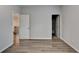 Neutral bedroom showcasing wood floors, soft gray walls, and open doorways at 2090 Harvester Ln, Buford, GA 30518