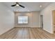 A spacious bedroom features natural light, a ceiling fan, and sleek wood-look floors at 2090 Harvester Ln, Buford, GA 30518