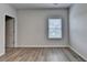 Bright bedroom featuring neutral paint, wood floors, and natural light from the window at 2090 Harvester Ln, Buford, GA 30518