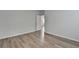 Bedroom featuring wood-look floors, light grey walls, and access to another room at 2090 Harvester Ln, Buford, GA 30518