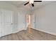 Bedroom features modern lighting, ceiling fan, doors to closets, and wood floors at 2090 Harvester Ln, Buford, GA 30518