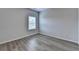 Bedroom with light gray walls, wood floors and a window with blinds at 2090 Harvester Ln, Buford, GA 30518