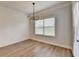 Dining area with wainscoting, wood floors, and modern light fixture offers a cozy atmosphere at 2090 Harvester Ln, Buford, GA 30518