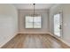 Dining area features wood floors, wainscoting, and a modern light fixture at 2090 Harvester Ln, Buford, GA 30518