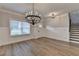 Charming dining room with a modern light fixture and wood-look floors at 2090 Harvester Ln, Buford, GA 30518
