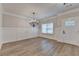 Bright entryway with wainscoting, modern lighting, and wood-look flooring at 2090 Harvester Ln, Buford, GA 30518