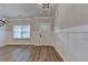 Inviting entryway with a classic paneled door, stylish wainscoting, and durable wood-look floors at 2090 Harvester Ln, Buford, GA 30518