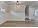 Entryway featuring wainscoting, modern lighting, and hardwood floors at 2090 Harvester Ln, Buford, GA 30518