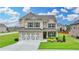 Stunning two-story brick home with a two-car garage, well-maintained lawn, and mature landscaping at 2090 Harvester Ln, Buford, GA 30518