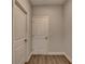 Hallway with wood floors and white doors at 2090 Harvester Ln, Buford, GA 30518