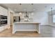 Gourmet kitchen featuring a large center island, stainless steel appliances, and contemporary pendant lighting at 2090 Harvester Ln, Buford, GA 30518