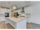 Bright kitchen features an island with a stone countertop, stainless steel appliances, and white cabinets at 2090 Harvester Ln, Buford, GA 30518