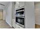 The kitchen features stainless double ovens and wood flooring at 2090 Harvester Ln, Buford, GA 30518