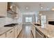 The bright kitchen features stainless appliances, subway tiles, and shaker cabinets at 2090 Harvester Ln, Buford, GA 30518